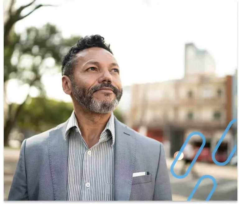An image of a well dressed man looking hopefully into sky.