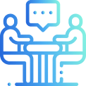 An image of two people at a table with a speech bubble in between the two.