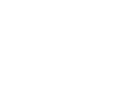 An image of a briefcase in front of a dartboard hit perfectlty in the center by an arrow.